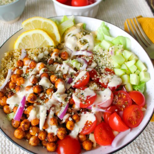 Shawarma-spiced chickpeas with lemon quinoa, cucumber, tomatoes, and tahini sauce
