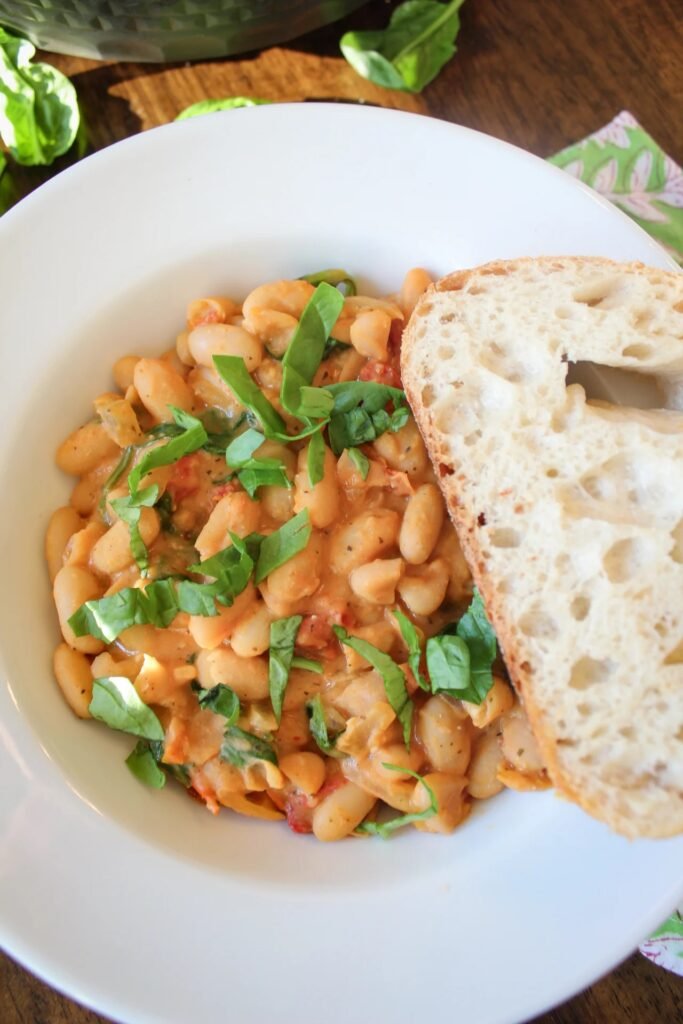 Creamy Tuscan white beans with cannellini beans, spinach, and sun-dried tomatoes